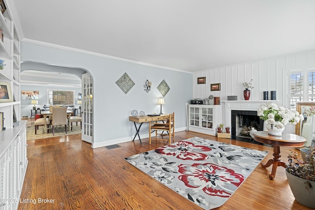 living room with hardwood / wood-style floors and ornamental molding