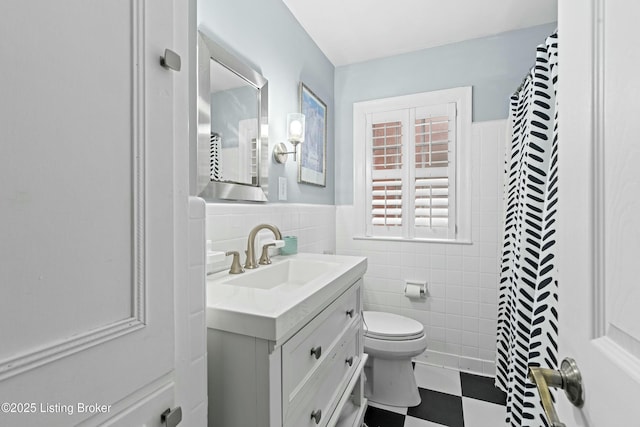 bathroom with tile walls, vanity, toilet, and a shower with shower curtain