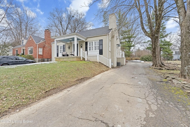 view of front of home with a porch and a front yard