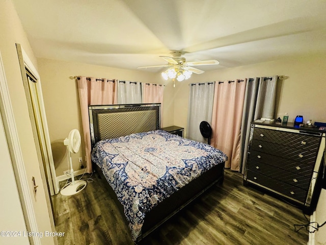 bedroom featuring a closet, dark hardwood / wood-style floors, and ceiling fan