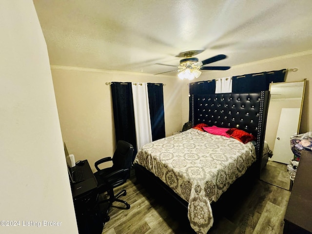 bedroom with wood-type flooring, ornamental molding, and ceiling fan