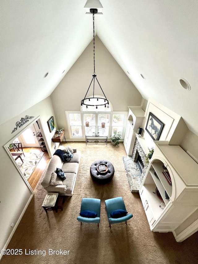 living room featuring carpet flooring and high vaulted ceiling