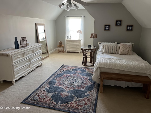 bedroom with vaulted ceiling, light colored carpet, and ceiling fan