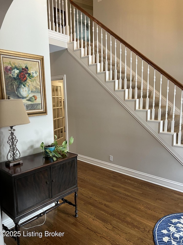 stairs featuring hardwood / wood-style floors