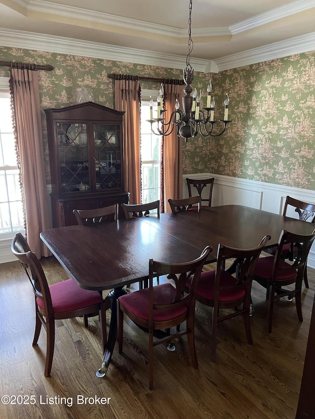 dining space featuring ornamental molding, a chandelier, and hardwood / wood-style floors