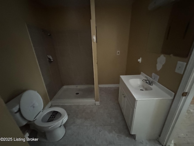 full bath featuring tile patterned flooring, a shower stall, baseboards, toilet, and vanity