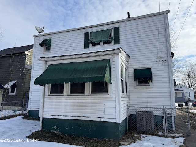 rear view of property featuring fence