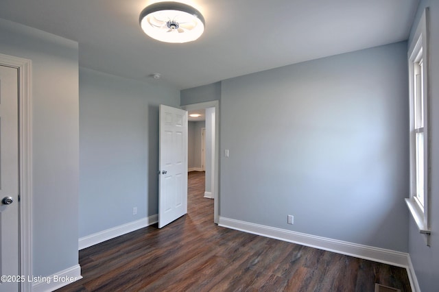 unfurnished bedroom with dark hardwood / wood-style flooring