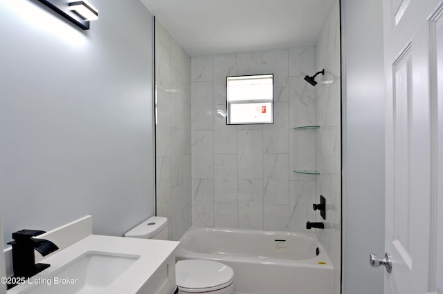 full bathroom with tiled shower / bath, vanity, and toilet