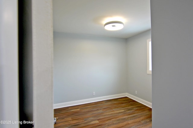 empty room with dark wood-type flooring