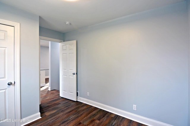 unfurnished bedroom featuring dark wood-type flooring