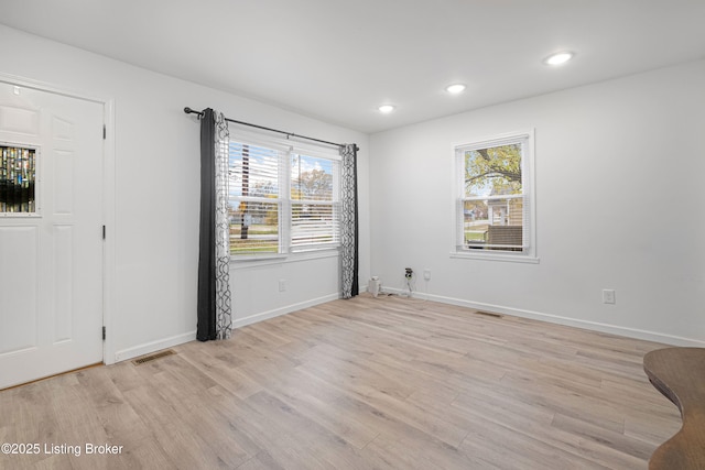 spare room with light hardwood / wood-style floors