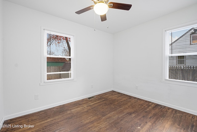 spare room featuring ceiling fan and dark hardwood / wood-style flooring