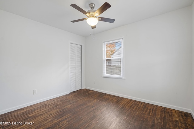 unfurnished room featuring ceiling fan and dark hardwood / wood-style flooring