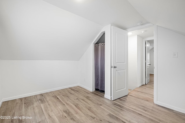 bonus room featuring lofted ceiling and light hardwood / wood-style floors