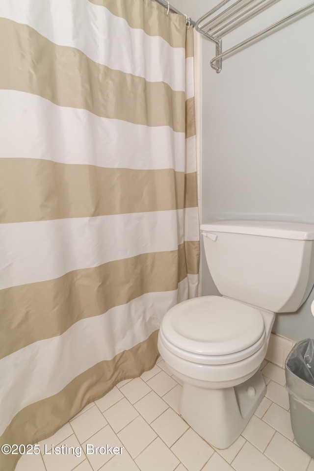 bathroom with tile patterned flooring and a shower with shower curtain