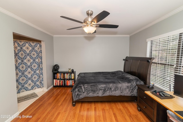 bedroom with ornamental molding, ceiling fan, and light wood-type flooring