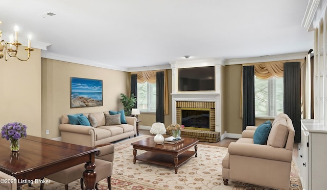 living room with crown molding, a fireplace, an inviting chandelier, and light wood-type flooring