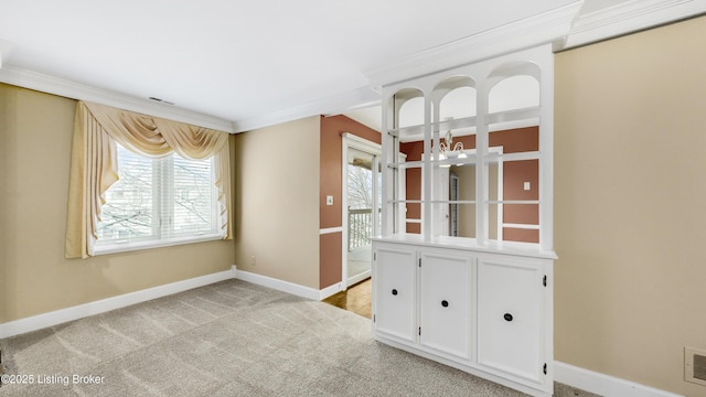 carpeted spare room with crown molding