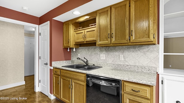 kitchen with black dishwasher, sink, backsplash, dark parquet flooring, and light stone countertops