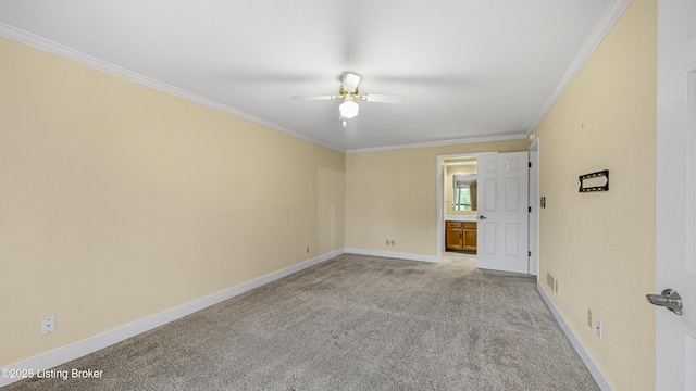 spare room with ceiling fan, light colored carpet, and ornamental molding