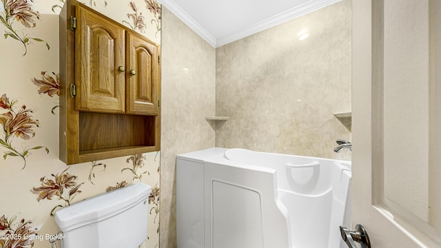 bathroom with crown molding, a bathtub, and toilet