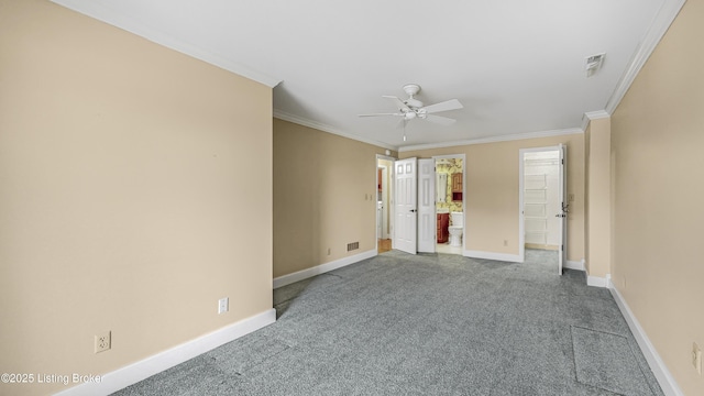 empty room featuring crown molding, ceiling fan, and carpet flooring