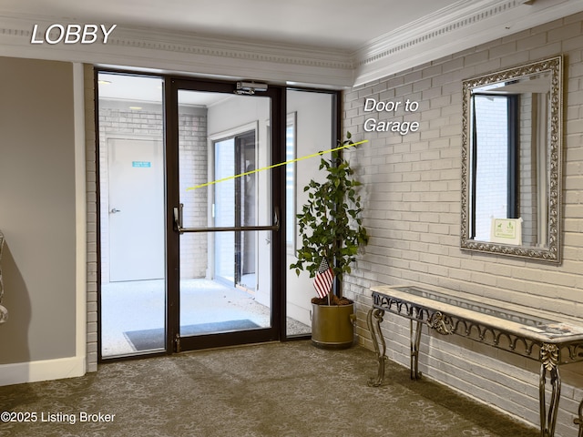 doorway to outside with carpet, a wealth of natural light, ornamental molding, and brick wall