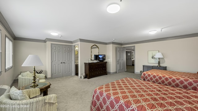 bedroom with crown molding, carpet flooring, and a closet