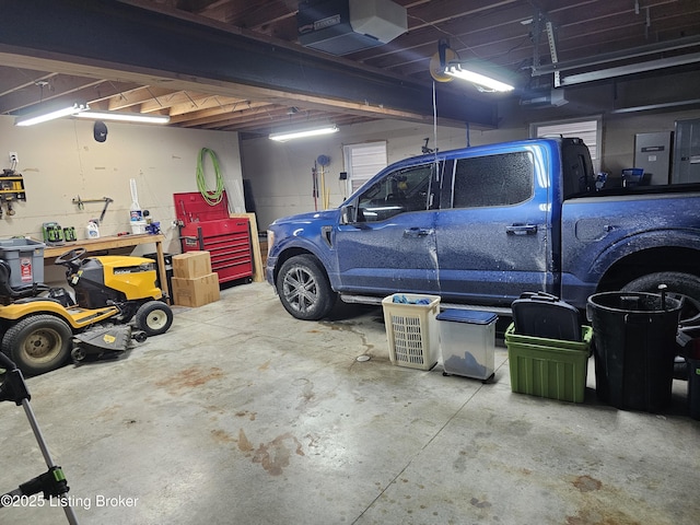 garage with a garage door opener and a workshop area