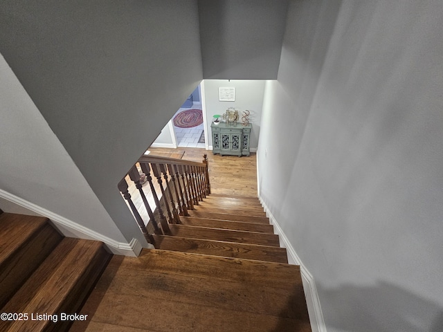 stairway with hardwood / wood-style flooring