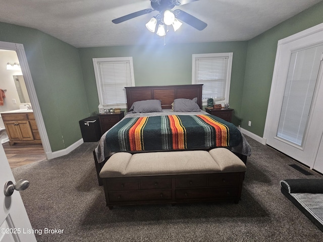 bedroom with sink, ensuite bath, ceiling fan, and carpet flooring