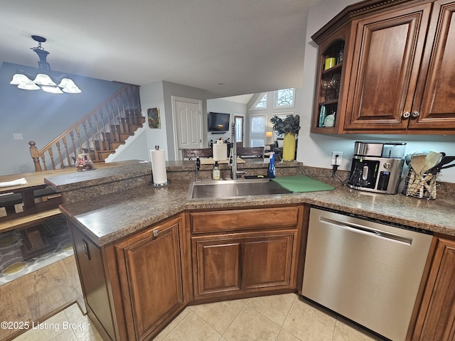 kitchen with sink, a chandelier, hanging light fixtures, stainless steel dishwasher, and kitchen peninsula