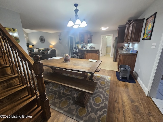 dining room with a chandelier and light wood-type flooring