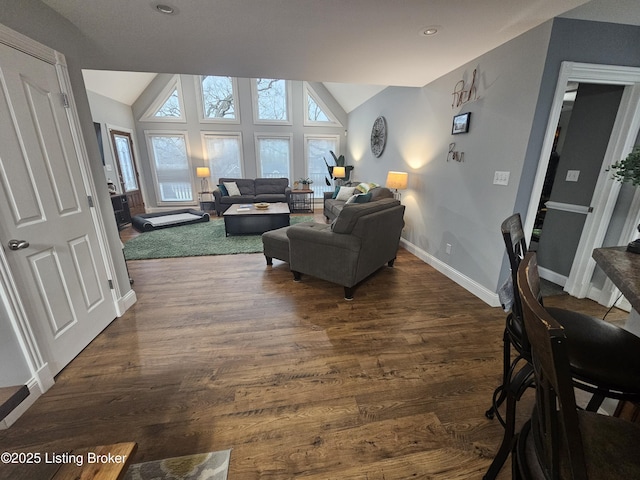 living room with dark hardwood / wood-style flooring and vaulted ceiling