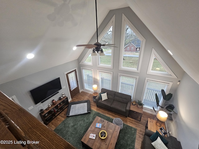 living room featuring ceiling fan, wood-type flooring, and high vaulted ceiling