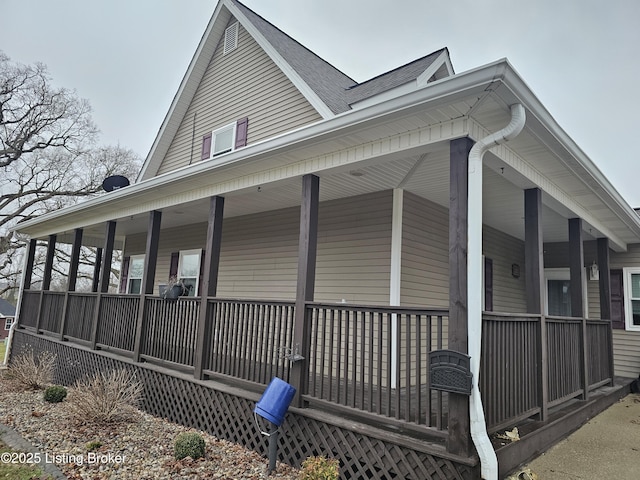 view of side of home with covered porch