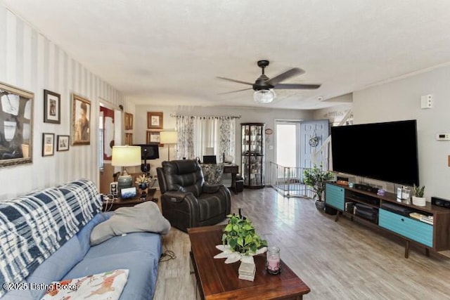 living room with wood-type flooring and ceiling fan