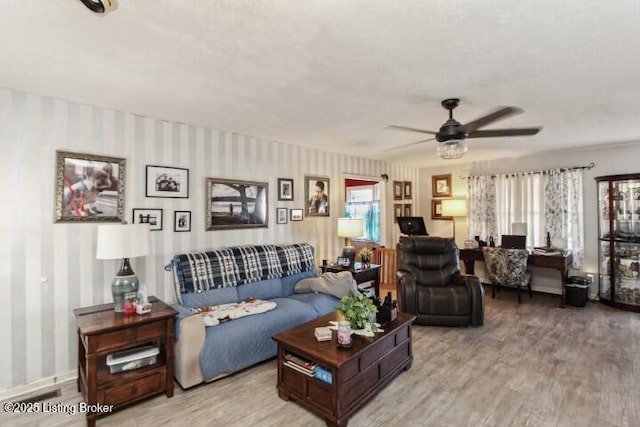 living room with radiator, ceiling fan, and light hardwood / wood-style flooring