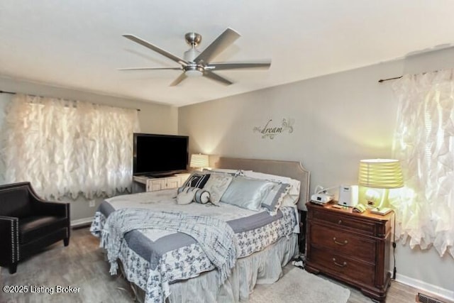 bedroom featuring wood-type flooring and ceiling fan