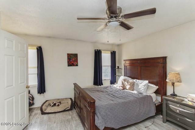 bedroom with ceiling fan and light hardwood / wood-style flooring