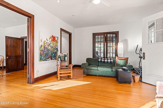 living room with hardwood / wood-style flooring and ceiling fan