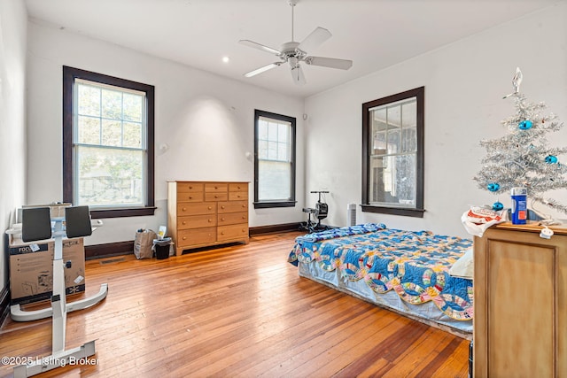 bedroom with ceiling fan and hardwood / wood-style floors