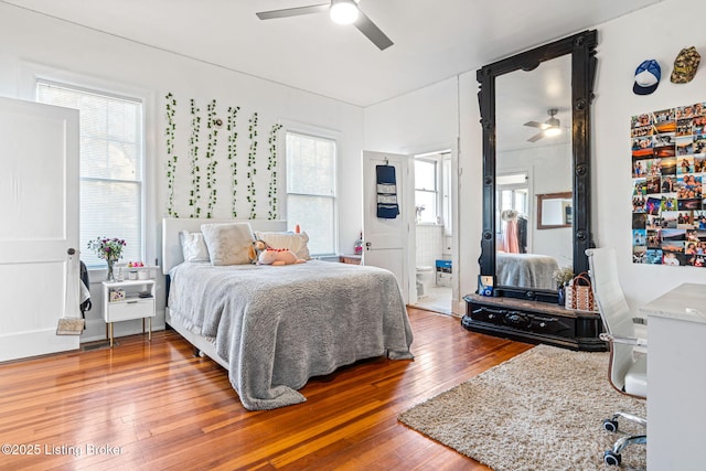 bedroom with hardwood / wood-style flooring, ceiling fan, and ensuite bathroom