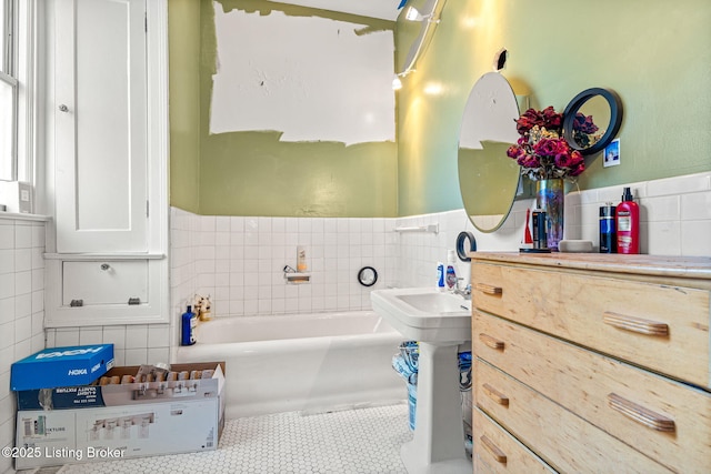 bathroom featuring tile walls, a bath, and tile patterned floors