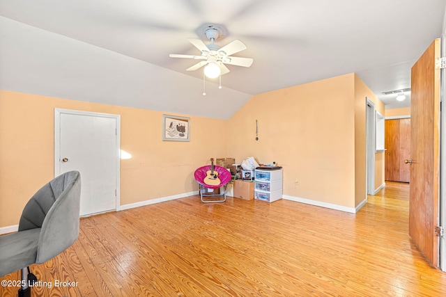 home office featuring ceiling fan, lofted ceiling, and light hardwood / wood-style floors