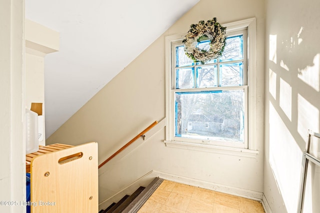 stairway with vaulted ceiling