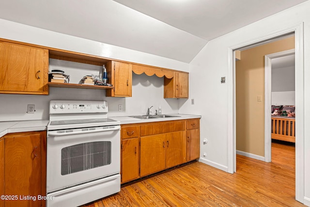 kitchen with sink, vaulted ceiling, light hardwood / wood-style floors, and white range with electric cooktop