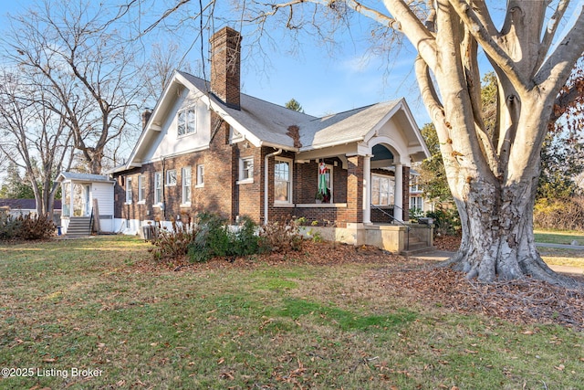 view of front facade with cooling unit and a front lawn