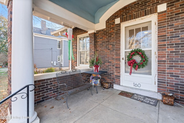 view of exterior entry with covered porch